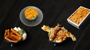 A dark tabletop setting featuring Sushi Zanmai’s EEL and UNI Special with grilled eel nigiri, fresh uni, and side dishes arranged neatly for a limited time promotion.